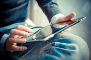 close up hands multitasking man using tablet, laptop and cellhpone connecting wifi