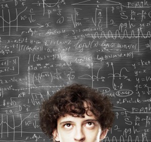 thinking man against desk with formulas