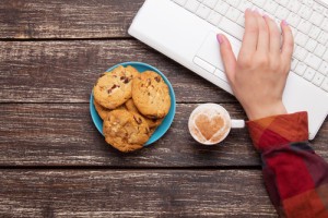 Cookie and women hand with notebook.