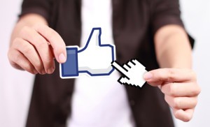 Johor, Malaysia - July 21, 2013: This 'like' icon button is the voting system used to rate user comments on Facebook. Low Shu Ching hand holding like icon on July 21, 2013 in Johor, Malaysia.