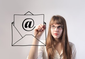 Businesswoman drawing an envelope with an e-mail sign